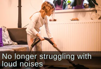Young girl vaccuuming her living room. Text: no longer struggling with loud noises