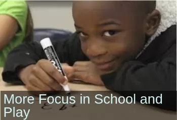 Boy looking into camera. Text: More focus in school and play.