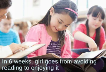 Smiling young girl reading a book in class. Text: In 6 weeks, girl goes from avoiding reading to enjoying it.