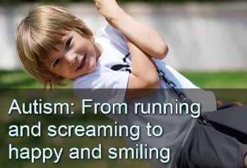 Smiling boy swinging on a swing set. Autism: From running and screaming to happy and smiling.