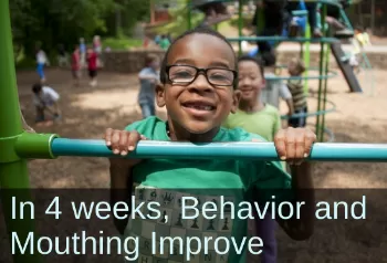 Boy playing on the playground. Text: In 4 weeks behavior and mouthing improve.