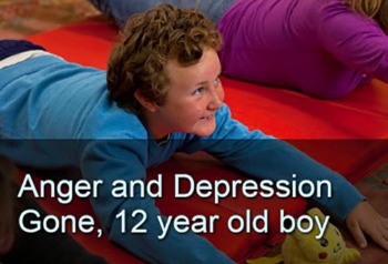 Boy in prone playing on gym mat, smiling. Text: Anger and depression gone, 12 year old boy