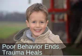 Young boy smiling. Text: Boy with trauma makes so much progress in school.