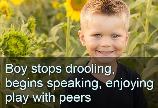 Smiling boy in a field of sunflowers. Text: Boy stops drooling, begins speaking, enjoying play with peers.