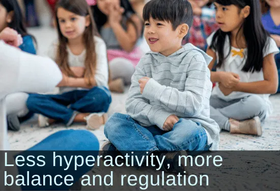 Smiling kindergartener sitting at circle time. Text: Less hyperactivity, more balance and regulation
