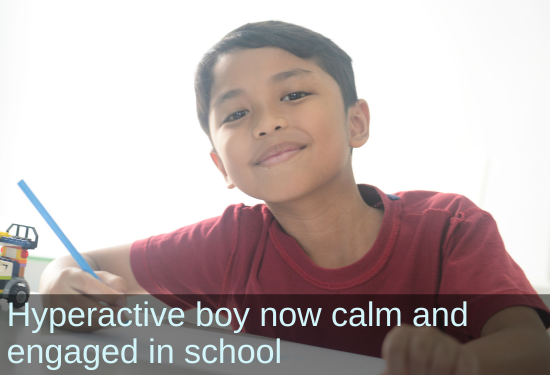 Boy working on homework. Text: Hyperactive boy now calm and engaged in school