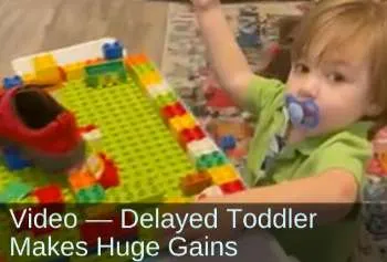 Young boy playing with Legos. Text: Video—Delayed toddler makes huge gains.