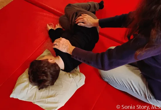 Therapist demonstrating rhythmic movements