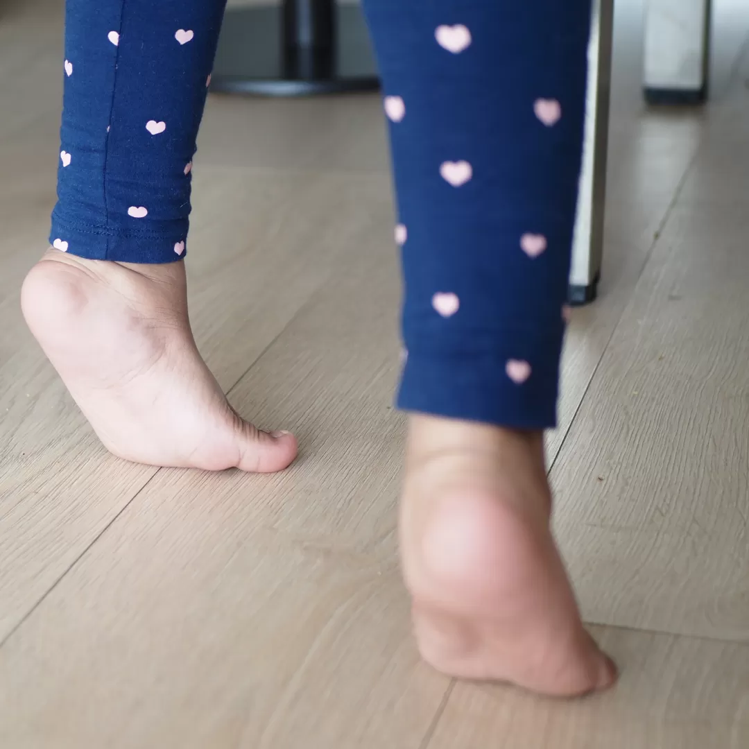 photo of child's legs and feet showing toe walking, walking on tip toes